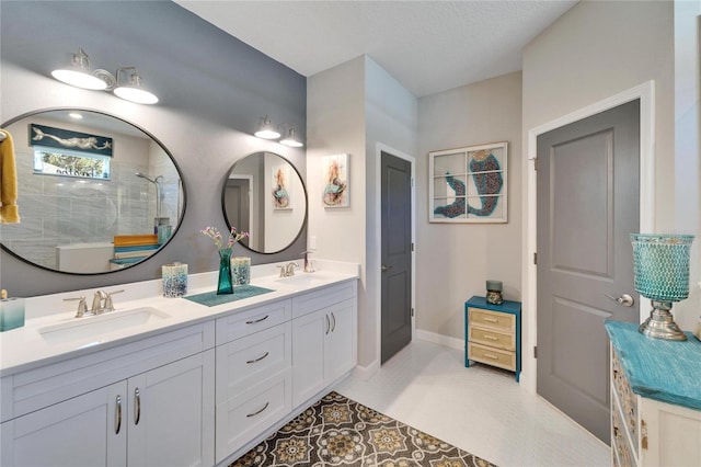 bathroom featuring tile patterned flooring, a shower, and vanity