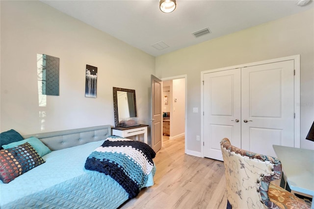 bedroom with a closet and light hardwood / wood-style floors