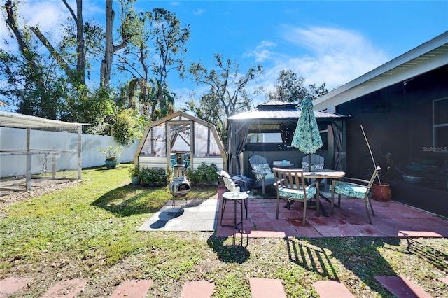 view of yard featuring a patio, an outdoor structure, and a gazebo