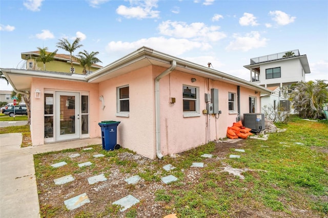 view of home's exterior with a yard and central AC