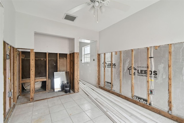 interior space with ceiling fan and tile patterned floors