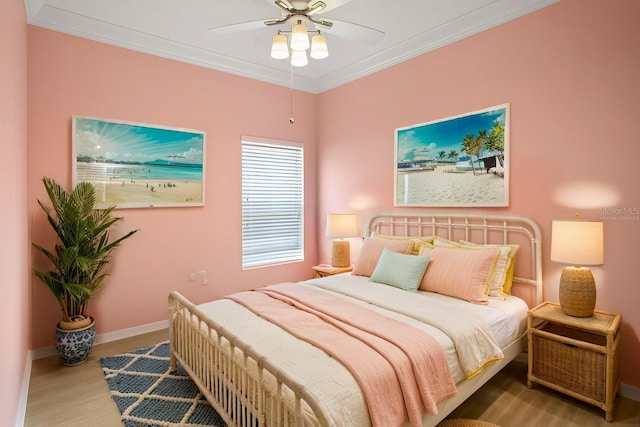 bedroom with ceiling fan, crown molding, and hardwood / wood-style flooring