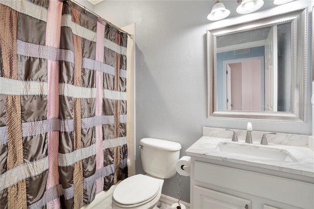 bathroom featuring toilet and vanity