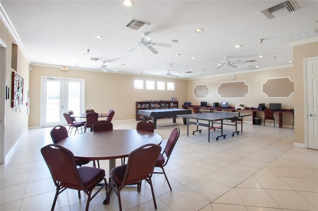 dining space featuring a textured ceiling, light tile patterned flooring, crown molding, and french doors