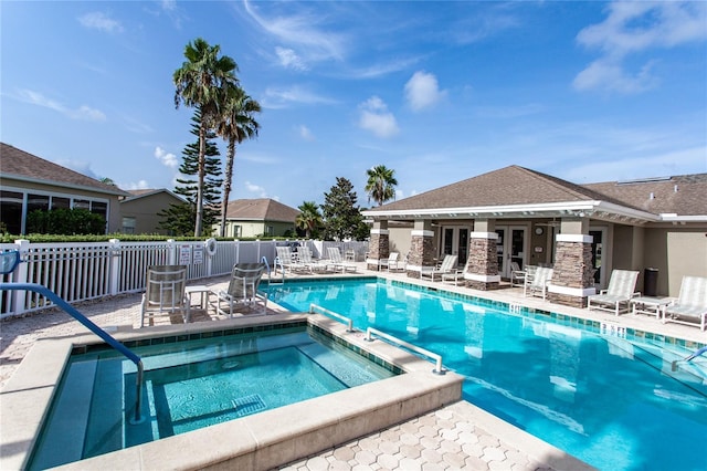 view of swimming pool featuring a patio area and a community hot tub