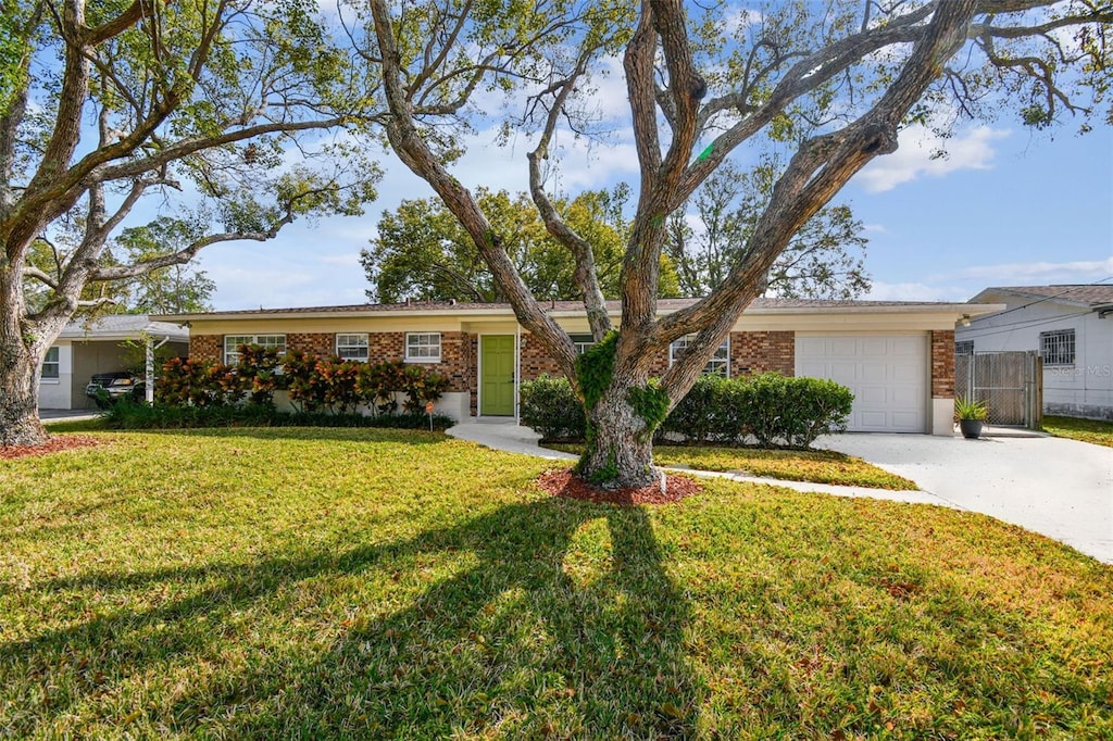 ranch-style home featuring a front yard and a garage