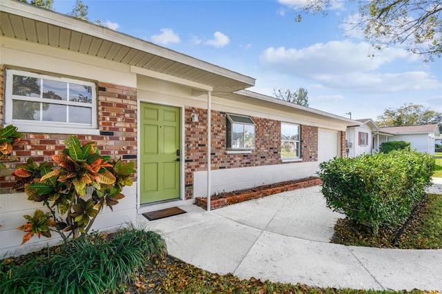 view of exterior entry featuring a garage