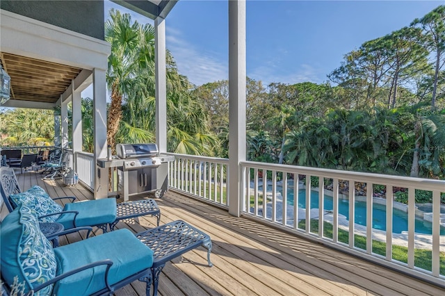 wooden terrace featuring a water view and a beach view