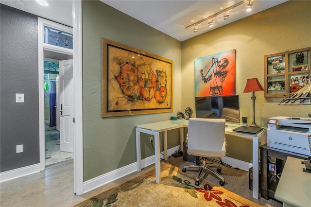 office featuring rail lighting and hardwood / wood-style flooring