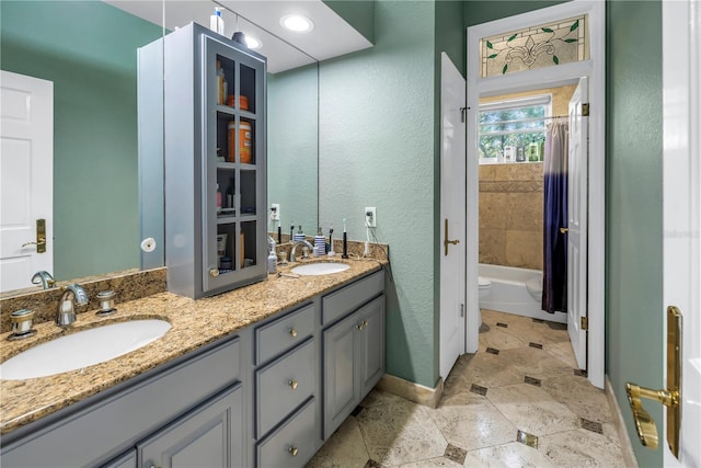 full bathroom featuring vanity, toilet, and shower / bathtub combination with curtain