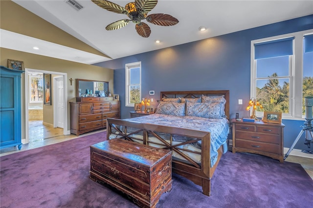 bedroom with ceiling fan, carpet, ensuite bath, and lofted ceiling