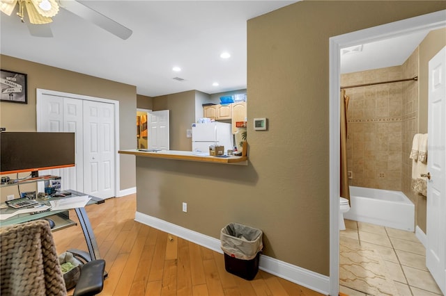 office featuring light hardwood / wood-style floors and ceiling fan