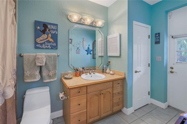 bathroom featuring vanity, toilet, and tile patterned floors