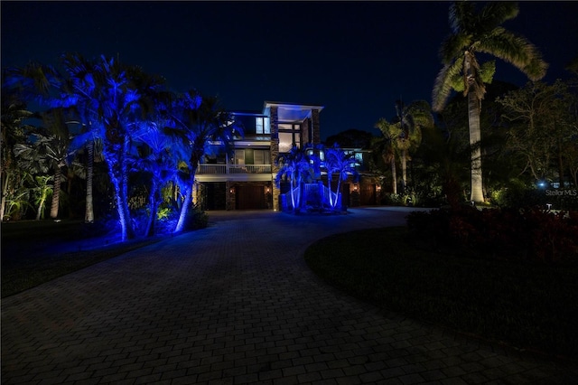 exterior space featuring decorative driveway and a balcony