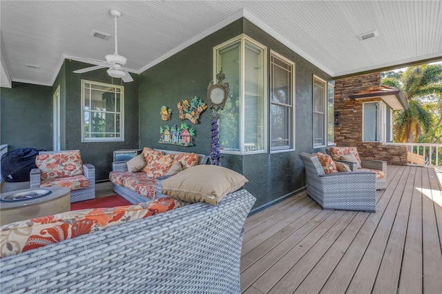 deck featuring ceiling fan, visible vents, and an outdoor living space