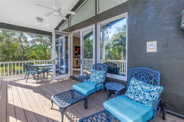 wooden deck featuring outdoor dining area and a ceiling fan