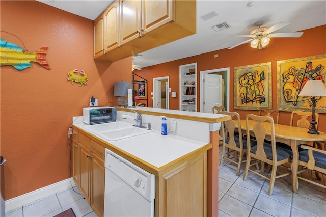 kitchen with visible vents, dishwasher, a peninsula, light countertops, and a sink