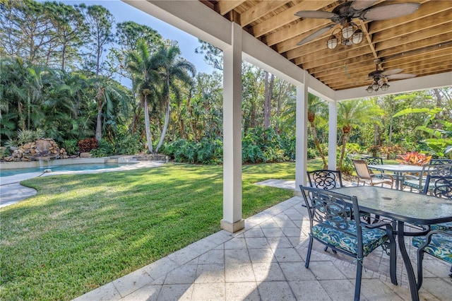 view of patio / terrace featuring ceiling fan, outdoor dining area, and an outdoor pool