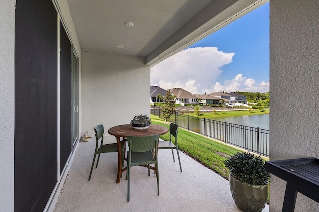 balcony with a water view and a patio area