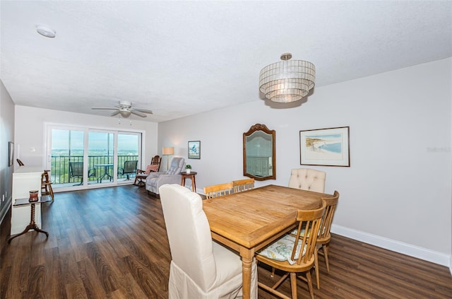 dining room featuring a textured ceiling, ceiling fan, and dark wood-type flooring