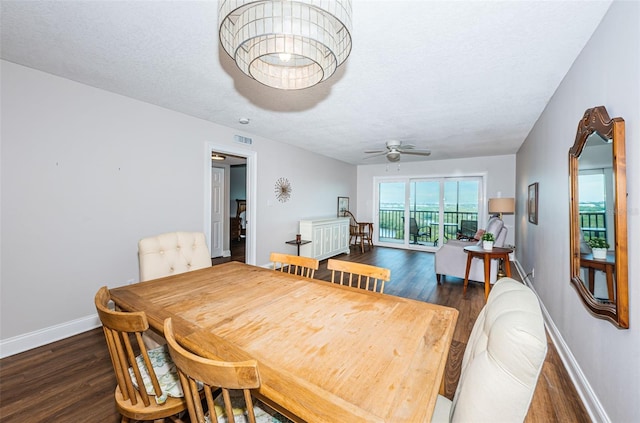 dining area featuring ceiling fan, dark hardwood / wood-style flooring, and a textured ceiling