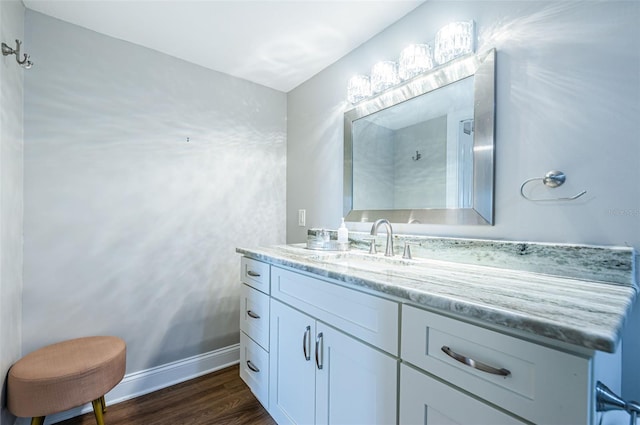 bathroom with hardwood / wood-style flooring and vanity