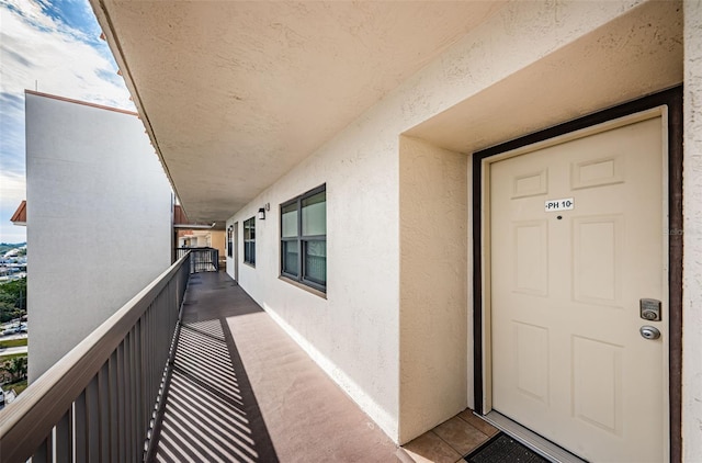 view of exterior entry with a balcony