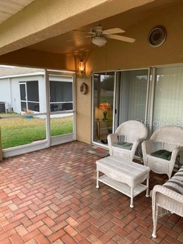 sunroom featuring ceiling fan