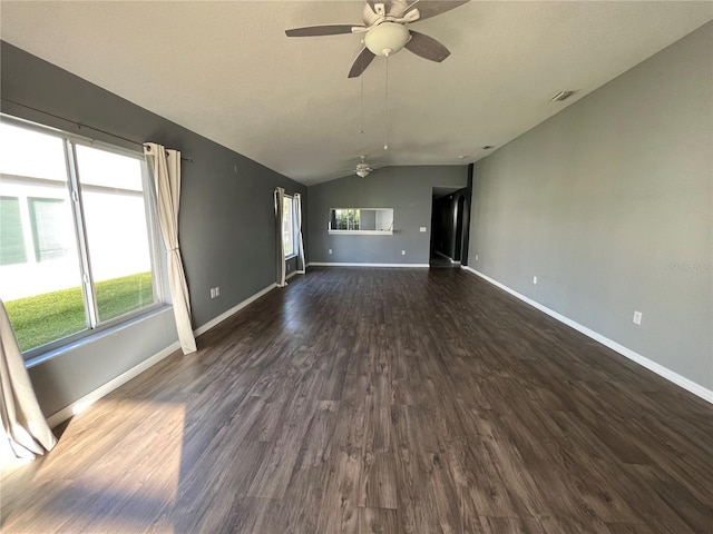 empty room featuring lofted ceiling, dark hardwood / wood-style floors, and ceiling fan