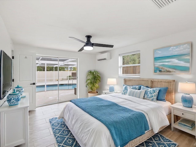 bedroom featuring an AC wall unit, access to exterior, ceiling fan, and multiple windows