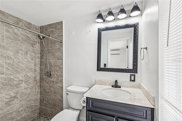 bathroom featuring a wall unit AC, vanity, toilet, and tiled shower