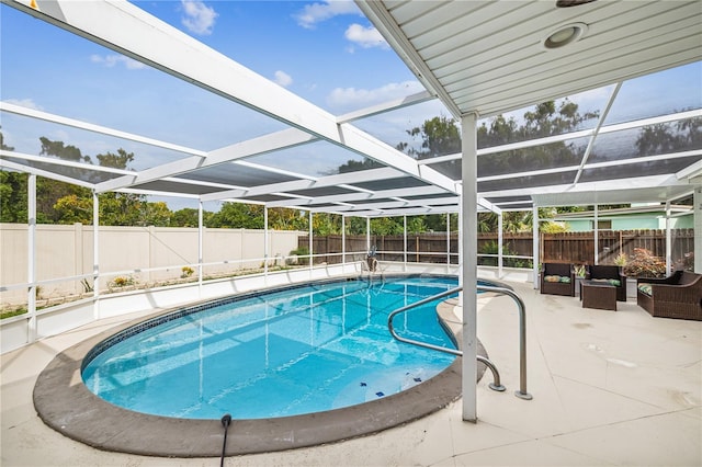 view of swimming pool with glass enclosure and a patio