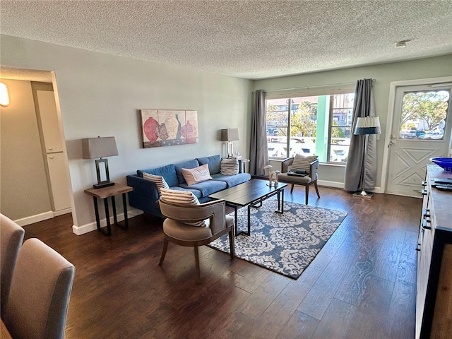 living room featuring dark hardwood / wood-style flooring and a textured ceiling