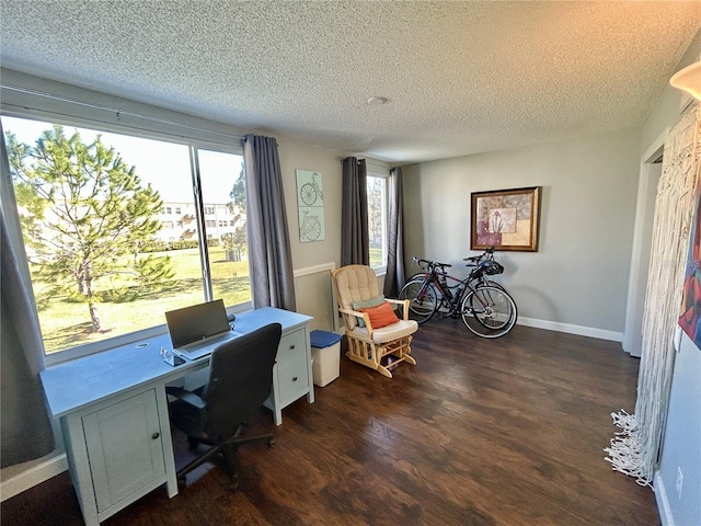 home office with dark hardwood / wood-style flooring and a textured ceiling