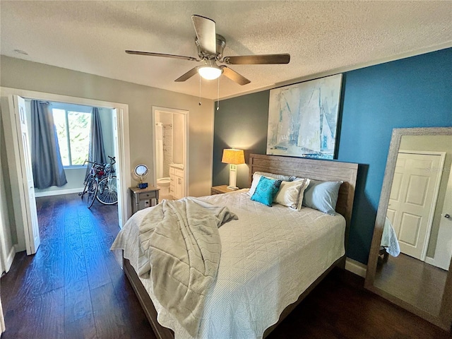 bedroom with ceiling fan, ensuite bathroom, a textured ceiling, and dark wood-type flooring