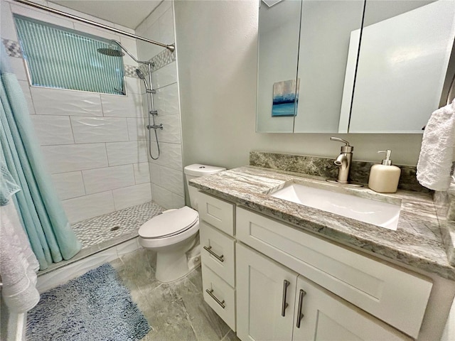 bathroom featuring a shower with shower curtain, vanity, and toilet