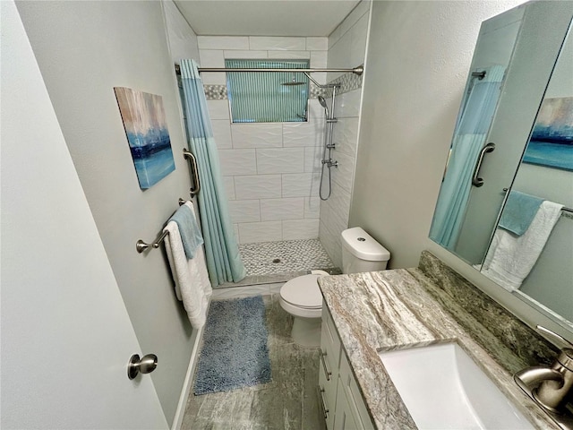 bathroom featuring curtained shower, vanity, and toilet