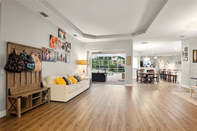 living room featuring ceiling fan and hardwood / wood-style flooring