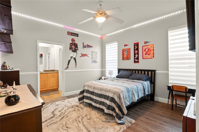 bedroom with ceiling fan, connected bathroom, and hardwood / wood-style flooring