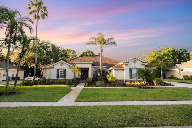 6020 Kestrel Point Ave, Lithia, FL 33547 - view of front of property featuring stucco siding, a lawn, and stone siding