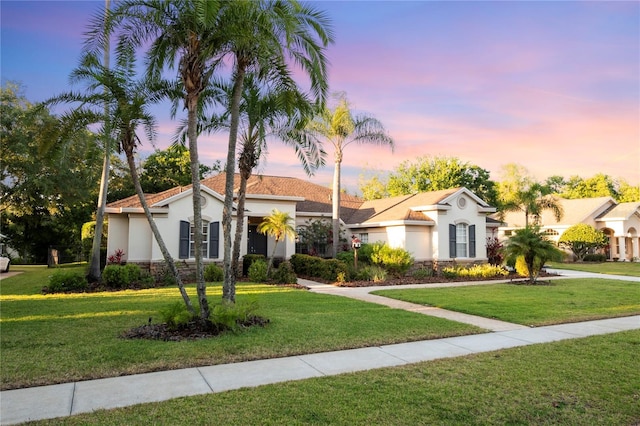 6020 Kestrel Point Ave, Lithia, FL 33547 - view of front of home featuring stucco siding, a yard, and stone siding
