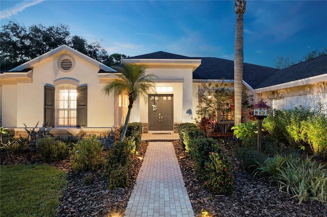 6020 Kestrel Point Ave, Lithia, FL 33547 - view of front of house with stucco siding and roof with shingles