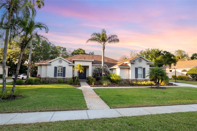 6020 Kestrel Point Ave, Lithia, FL 33547 - view of front of property featuring stucco siding, stone siding, and a front yard