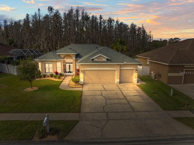 view of front facade with a garage and a yard