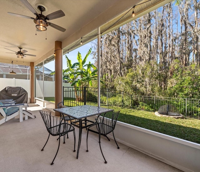 sunroom featuring ceiling fan