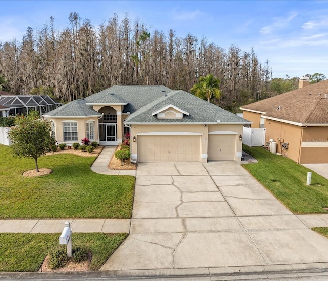 single story home featuring a garage and a front lawn