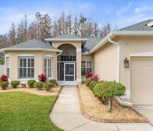 entrance to property with a yard and a garage