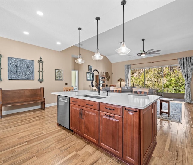 kitchen with pendant lighting, a kitchen island with sink, sink, and stainless steel dishwasher