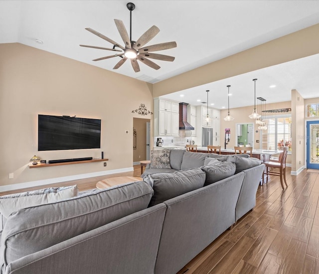 living room with dark hardwood / wood-style floors, ceiling fan, and lofted ceiling