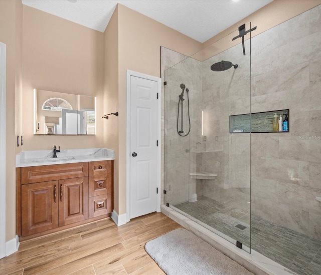 bathroom featuring vanity and tiled shower